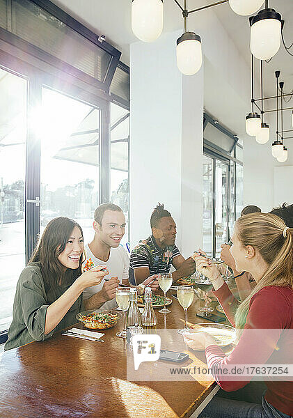 Group of friends enjoying meal in restaurant
