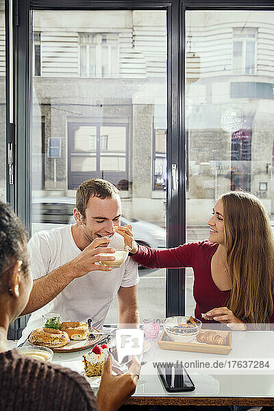 Smiling couple enjoying breakfast in restaurant