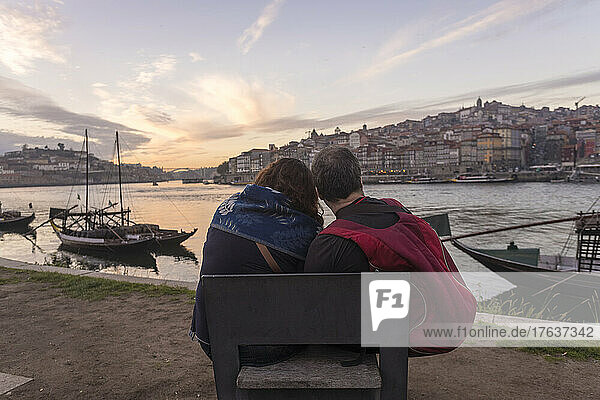 Portugal  Porto  Rear view of couple facing Douro river at sunset