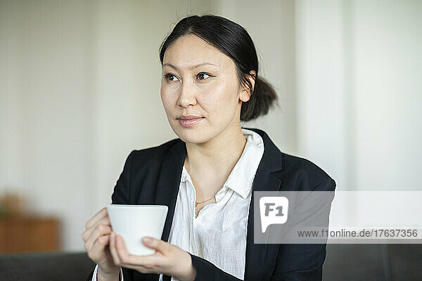 Businesswoman with coffee cup in office