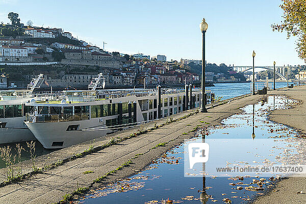 Portugal  Porto  Tourboat on Douro river with Dom Luis I Bridge in distance