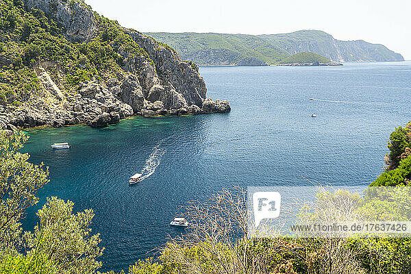Greece  Corfu island  Kerkyra  Boats in bay near rocky coast