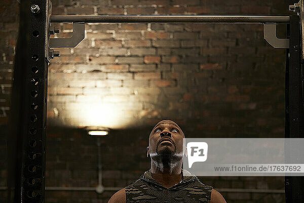 Muscular man looking up in gym