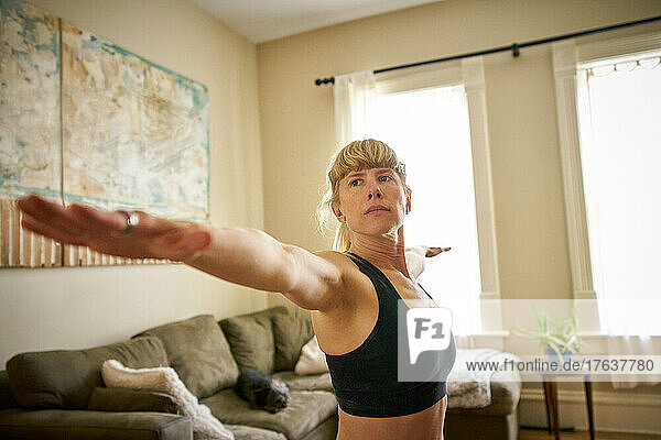 Mature woman practicing yoga at home