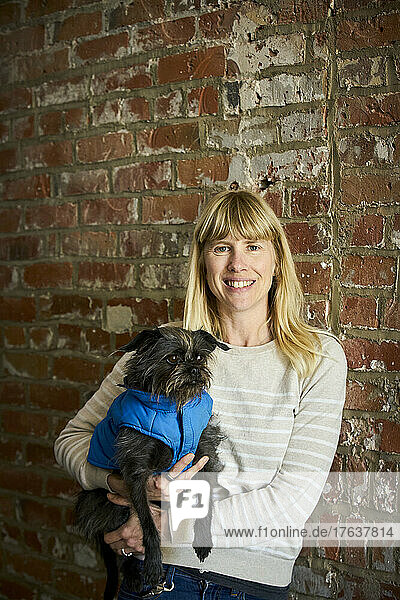 Portrait of smiling mature woman holding dog