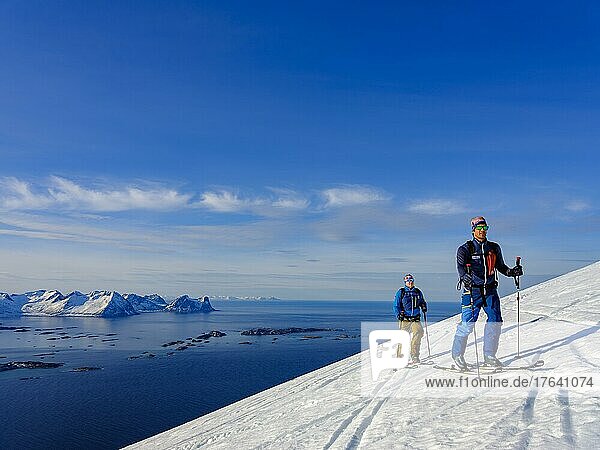 Two ski tourers on the ascent above Bergsfjord  Senja Island  Troms  Norway  Europe