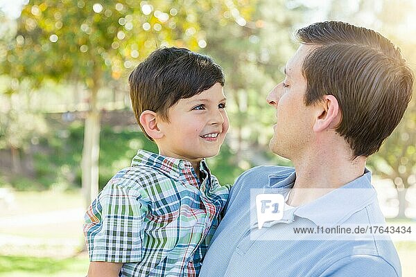 Happy caucasian father and son playing together in the park