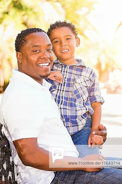 mixed-race son and african american father playing outdoors together