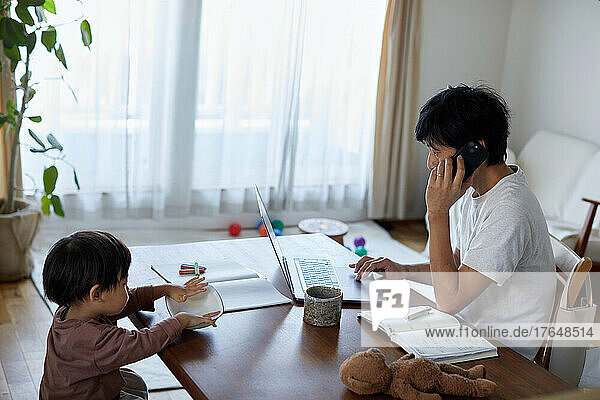 Japanese man working from home with kid