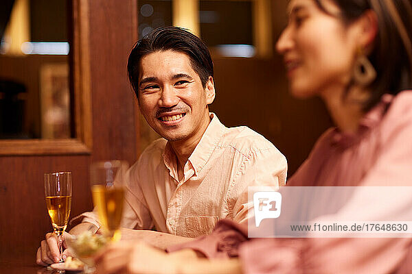 Japanese couple having a drink at a bar counter