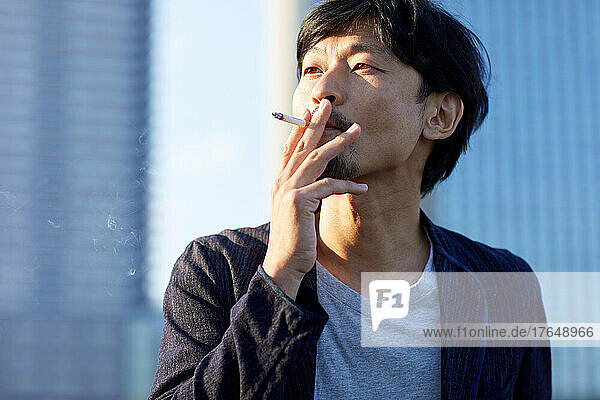 Japanese man smoking outside