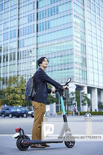 Japanese man with electric scooter