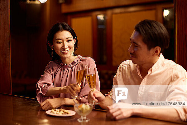 Japanese couple having a drink at a bar counter