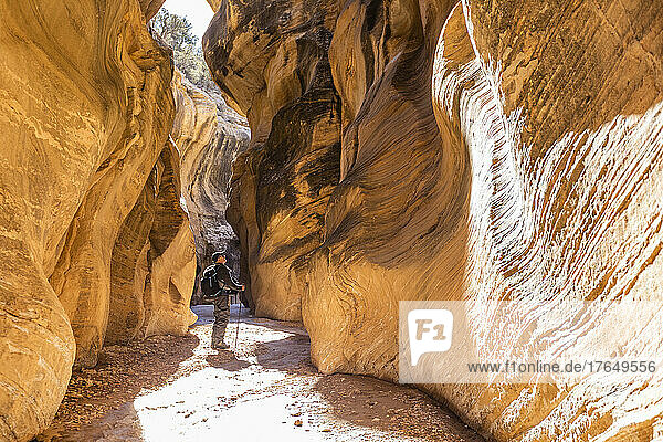 United States  Utah  Escalante  Senior hiker exploring slot canyon in Grand Staircase Escalante National Monument