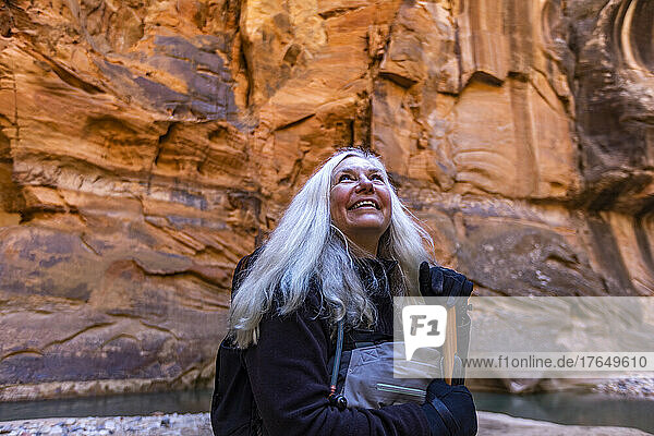 United States  Utah  Zion National Park  Smiling senior female hiker at The Narrows of Virgin River in Zion National Park