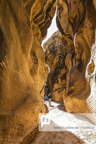 United States  Utah  Escalante  Rear view of senior female hiker exploring slot canyon in Grand Staircase Escalante National Monument