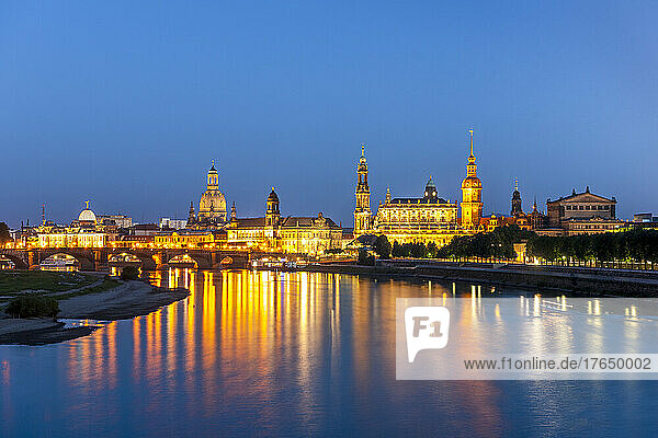 Germany  Saxony  Dresden  Long exposure of Elbe river at dusk with illuminated old town buildings in background