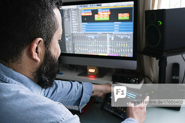 Composer creating music over tablet PC at home