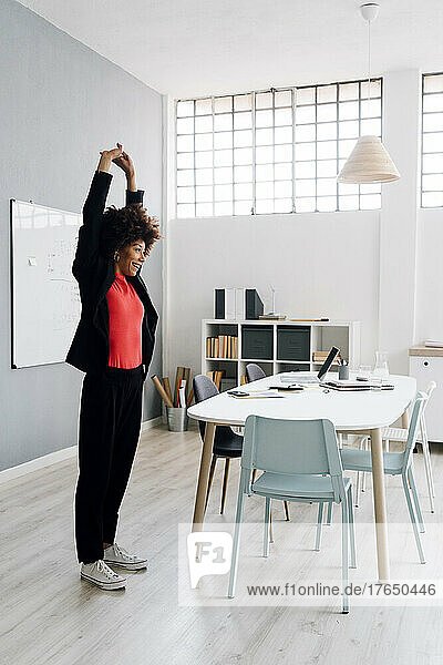 Young businesswoman doing stretching exercise at office