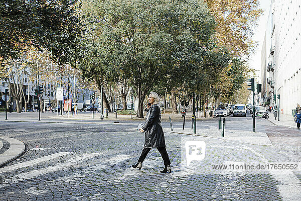 Woman walking on street in city