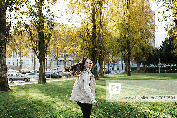 Happy woman enjoying at public park on sunny day