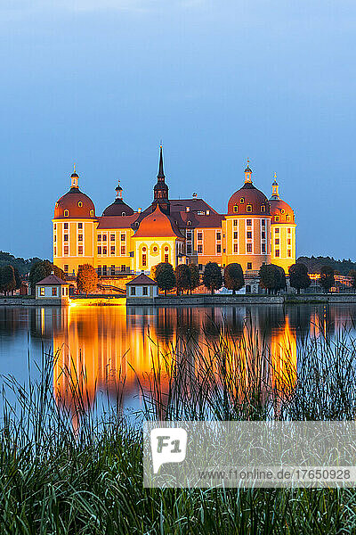 Germany  Saxony  Moritzburg  Long exposure of lake and illuminated Moritzburg Castle at dusk