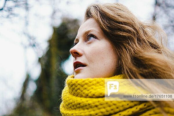 Beautiful woman with brown hair wearing yellow scarf