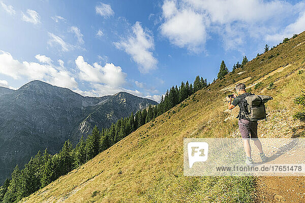 Male hiker taking photos in Karwendel range