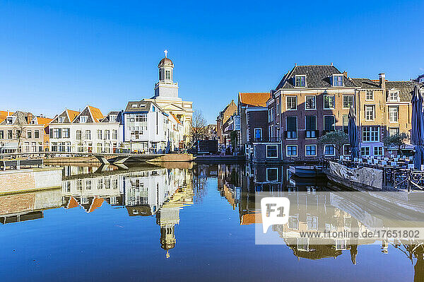 Netherlands  South Holland  Leiden  Church and surrounding townhouses reflecting in city canal