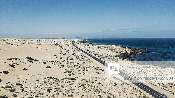 Spanien  Fuerteventura  Luftaufnahme einer Autobahn  die sich durch die sandige Landschaft des Naturparks Corralejo erstreckt