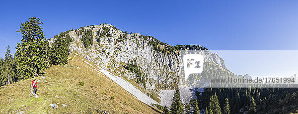 Panoramic view of female hiker admiring landscape of Bavarian Prealps
