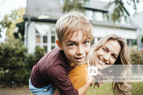Happy mother with son enjoying at backyard