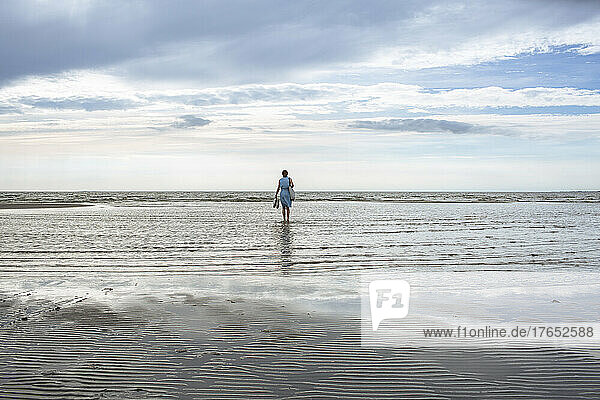 Girl standing in water at beach