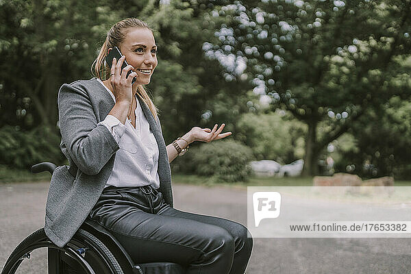 Disabled businesswoman talking on mobile phone