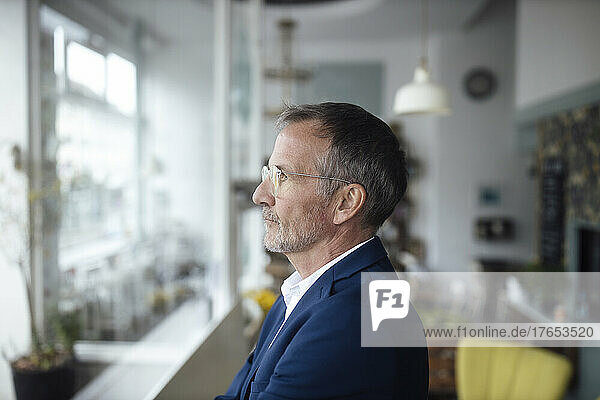 Businessman with eyeglasses standing in cafe