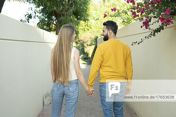Heterosexual couple walking on footpath