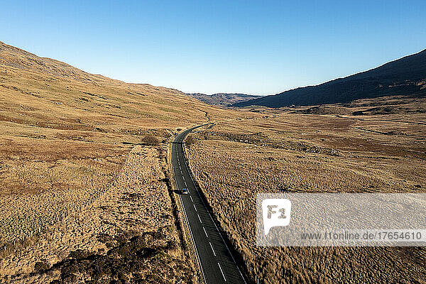UK  Wales  Aerial view of highway stretching along brown landscape of Snowdonia National Park