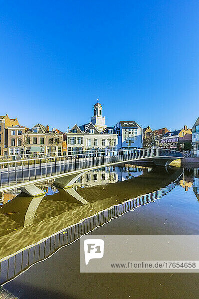 Netherlands  South Holland  Leiden  Clear sky over bridge stretching across city canal
