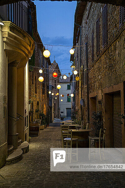 Italy  Province of Siena  Radicondoli  Lanterns illuminating old town alley