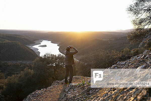 Spain  Province of Caceres  Man bird-watching in Monfrague National Park at sunset