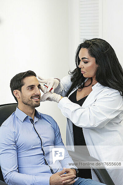 Dermatologist doing botox treatment on patient at medical clinic