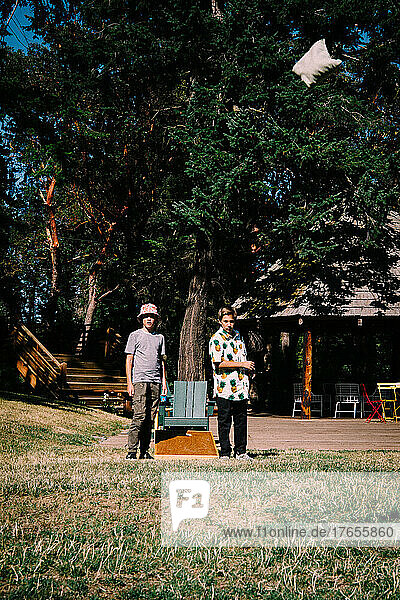 Two Boys Play Corn Hole at a Northwest Resort