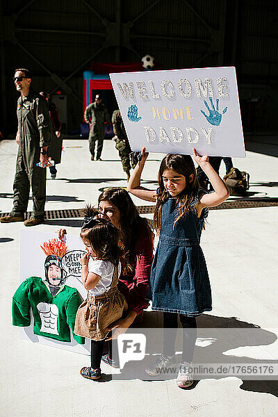 Seven Year Old Holding Sign for Military Dad's Return in San Diego