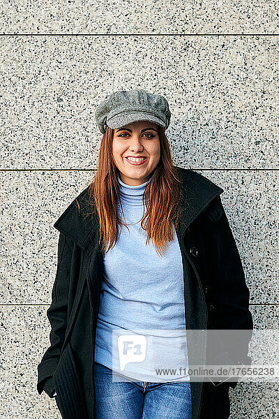 Portrait of a woman in casual clothes looking at camera on the street