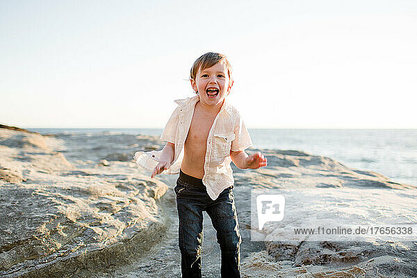 Excited Preschool Age Boy on Cliffs at Beach in San Diego