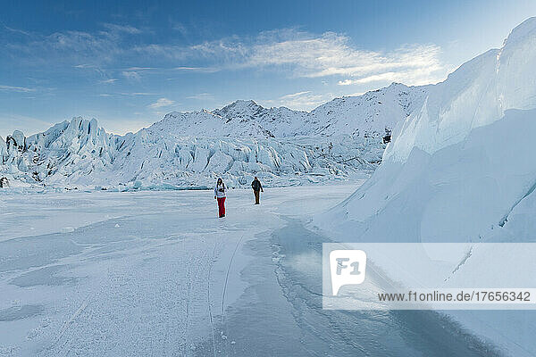 Two people walking on ice field at the Matanuska Glacier in Alaska