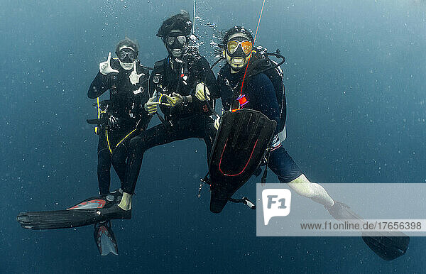 divers at safety stop while on a dive in the Maldives