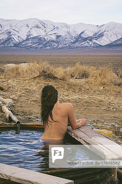 Naked female relaxing in hot springs