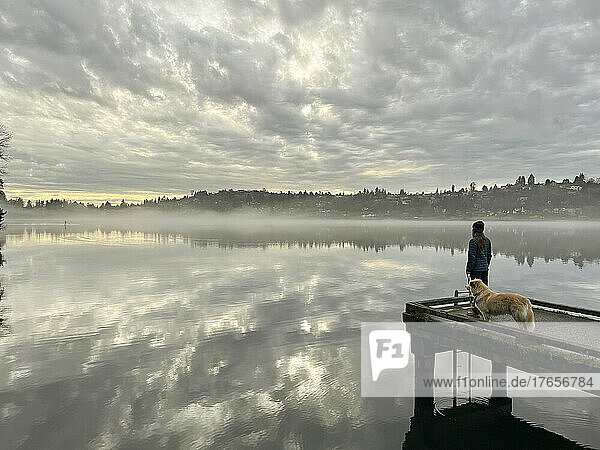 Female and their dog standing on dock at Seward Park