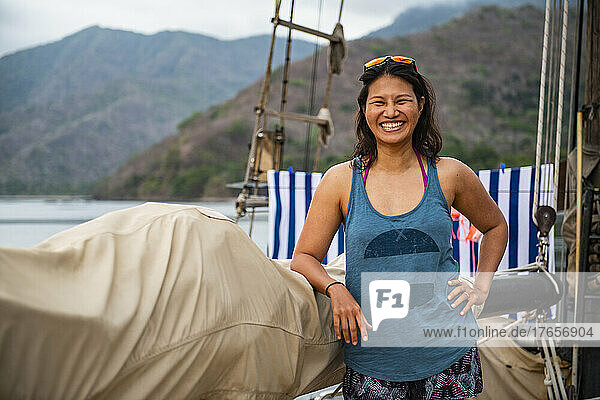 woman on deck of a sailboat of the coast of Komodo